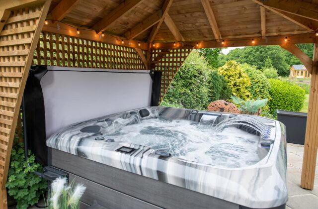 The Barcelona hot tub from Platinum Spas with its jets flowing under a canopy.