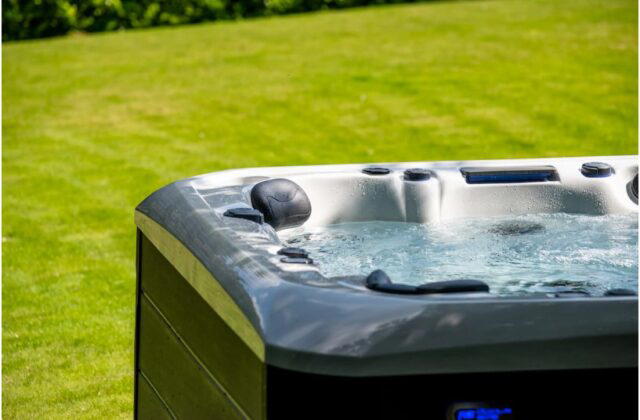 A close up of the Platinum Spas Tokyo hot tub, sitting on a lawn.