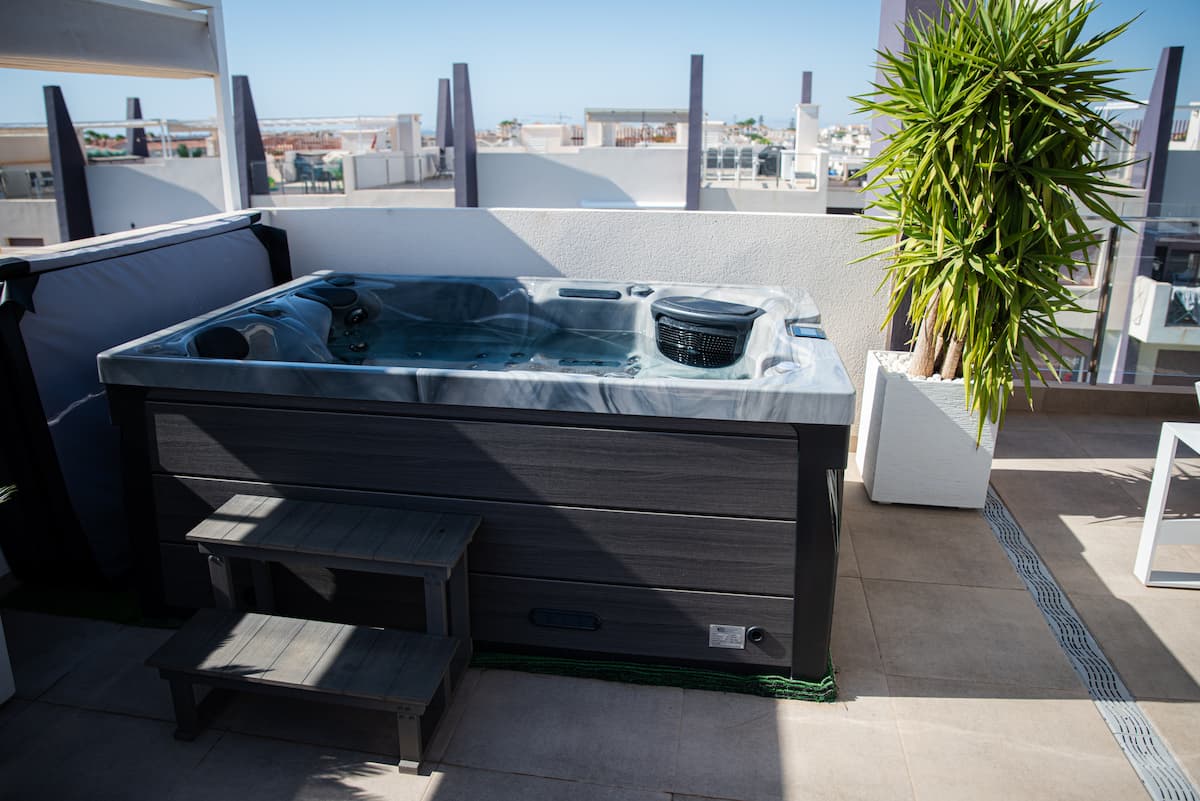 A Platinum Spas Topaz hot tub in Odyssey, on a rooftop terrace.