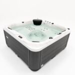 Platinum Spas Happy hot tub in white acrylic and dark cabinet, front three-quarter studio shot