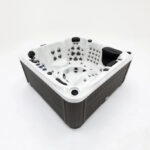 Platinum Spas Palma hot tub with lid open, showing the full six-seat interior and jet layout