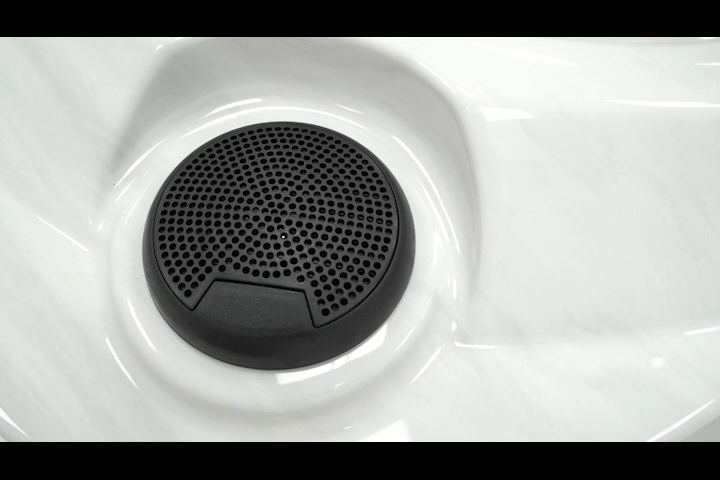 Platinum Melody Bluetooth speaker mounted on the rim of a Platinum Spas hot tub
