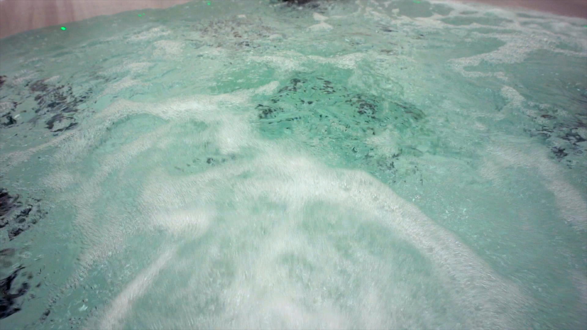 Hydrotherapy jets churning the water in a Platinum Spas hot tub