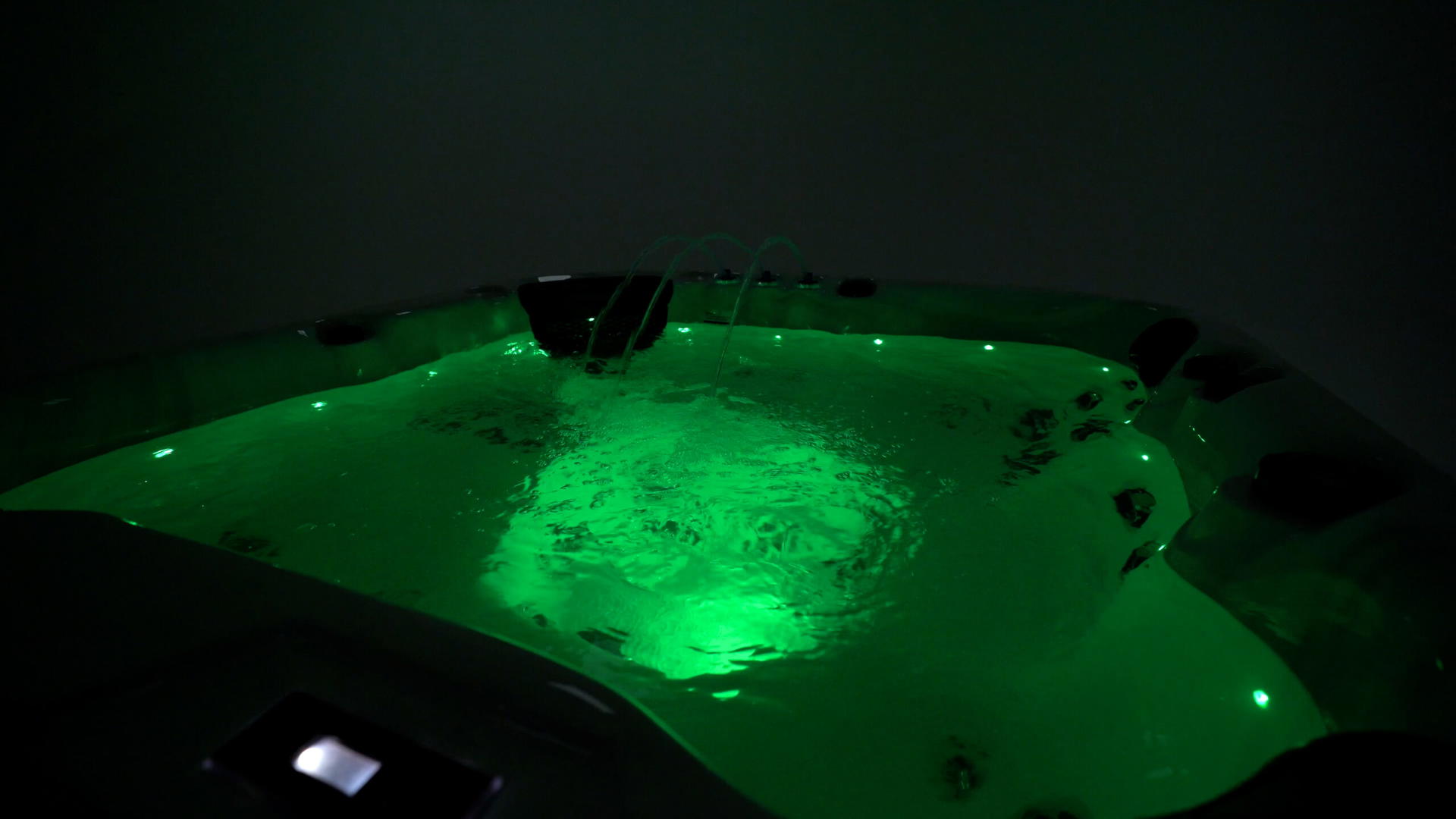 Blue LED lighting glowing inside a Platinum Spas hot tub at night