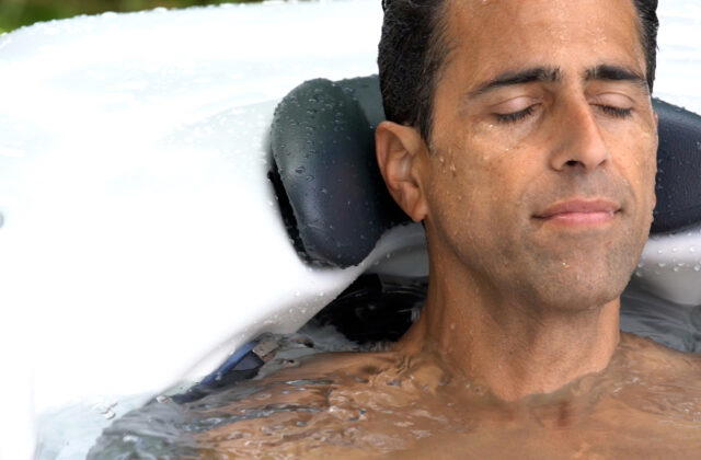 Man relaxing against the headrest of a Platinum Spas Portofino hot tub