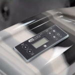 Close-up of the Platinum Spas control panel on a Refresh hot tub, showing temperature and mode buttons