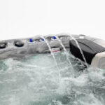 Close-up of the cascading waterfall feature beside a headrest on a Platinum Spas Refresh hot tub