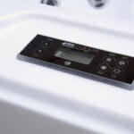 Angled view of the SpaTouch control panel built into the acrylic rim of a Platinum Spas Reims hot tub