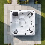 Overhead view of a Platinum Spas Reims hot tub on a paved patio
