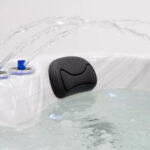 Platinum Spas Tahiti hot tub headrest with water fountain jets arching over the seat