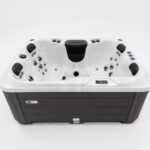 Platinum Spas Tahiti hot tub in Sterling Silver acrylic with dark gray cabinet, front view