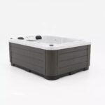 Platinum Spas Tahiti hot tub in Sterling Silver acrylic with dark gray cabinet, rear corner view