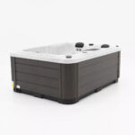 Platinum Spas Tahiti hot tub in Sterling Silver acrylic with dark gray cabinet, side angle view