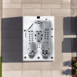 Overhead view of a Platinum Spas Topaz hot tub on a paved patio, showing two loungers and one seat