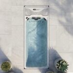 Platinum Spas Hades mini pool overhead render set into a paved patio with potted plants