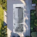 Platinum Spas Helios Pro swim spa overhead lifestyle composite render in a garden setting