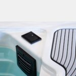 Touchscreen control pad and filter intake on the rim of a Platinum Spas mini pool