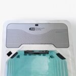 Looking down the length of a filled Platinum Spas mini pool towards the branded end panel