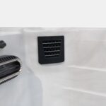 Filter intake grille on the side wall of a Platinum Spas mini pool