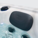 Platinum Spas Titan swim spa headrest close-up showing the Platinum Spas logo above bubbling jets