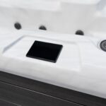 Platinum Spas Titan swim spa close-up of the SpaTouch touchscreen control panel on the cabinet rim