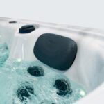 Platinum Spas Titan swim spa headrest close-up with surrounding jets bubbling in filled water