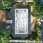 Platinum Spas Titan swim spa built into a wooden garden deck shown from an overhead lifestyle angle