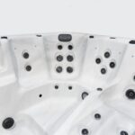 Platinum Spas Titan swim spa empty seating area close-up showing multiple hydrotherapy jet clusters