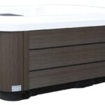 Platinum Spas Vacation Lounge hot tub with white cover closed, angled view of the cabinet and shell