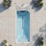 Platinum Spas Atlas mini pool shown from above on a paved patio surrounded by potted plants